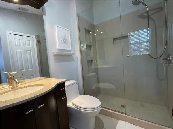 a bathroom with a shower and a toilet in it