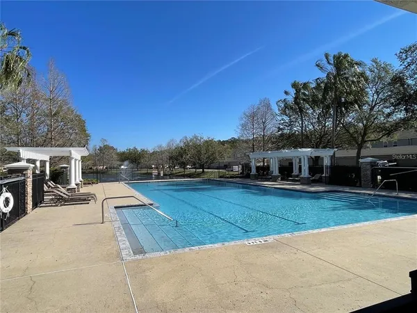a view of a patio with table and chairs with wooden floor and fence