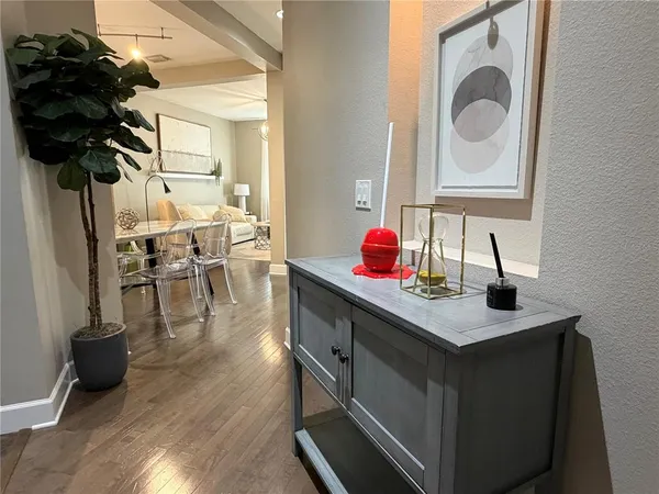 a kitchen with stainless steel appliances granite countertop a sink dishwasher and a dining table with wooden floor