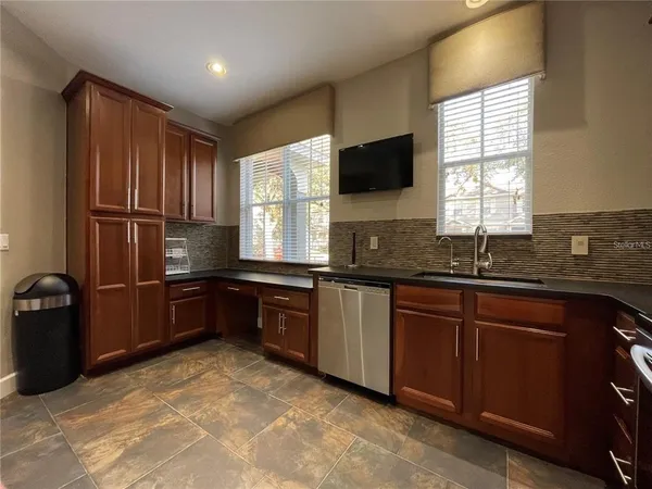 a kitchen with granite countertop a refrigerator stove and microwave