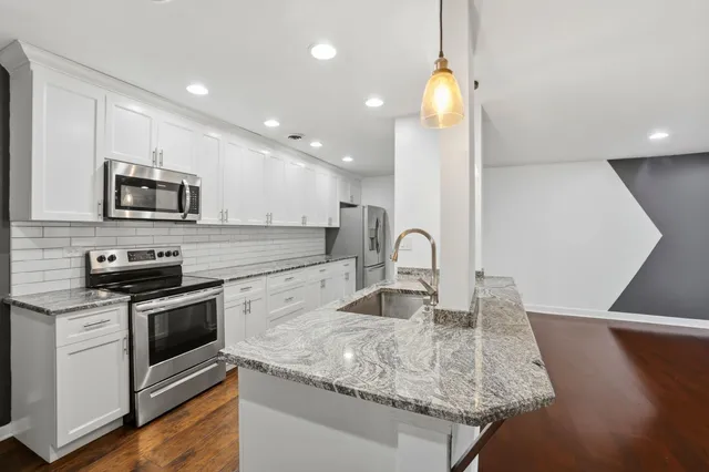 a kitchen with a stove and a microwave
