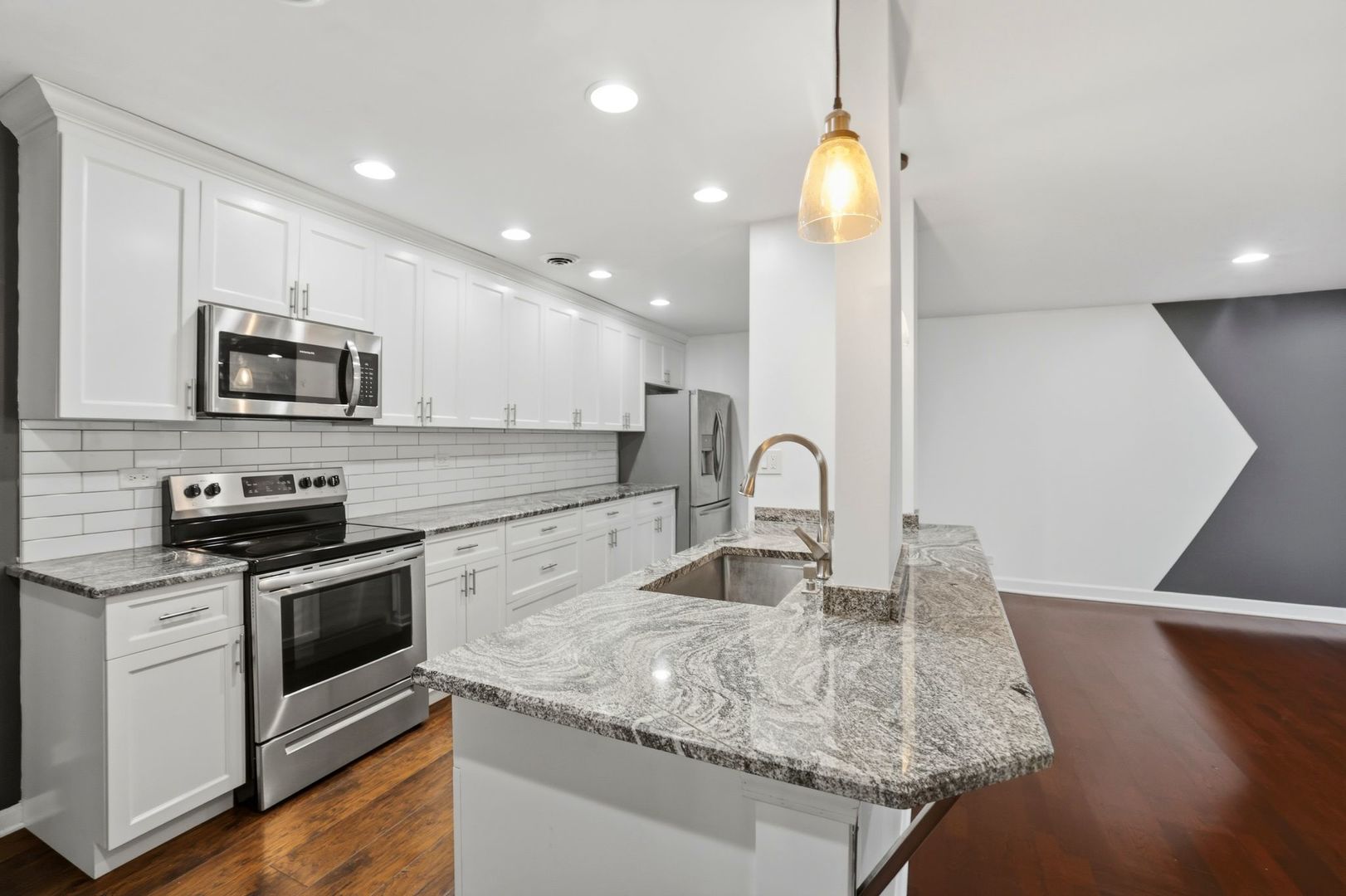 190 South Wood Dale Road, Unit 200 Wood Dale, IL 60191 - Photo 11 of 34 a kitchen with granite countertop a stove and a sink