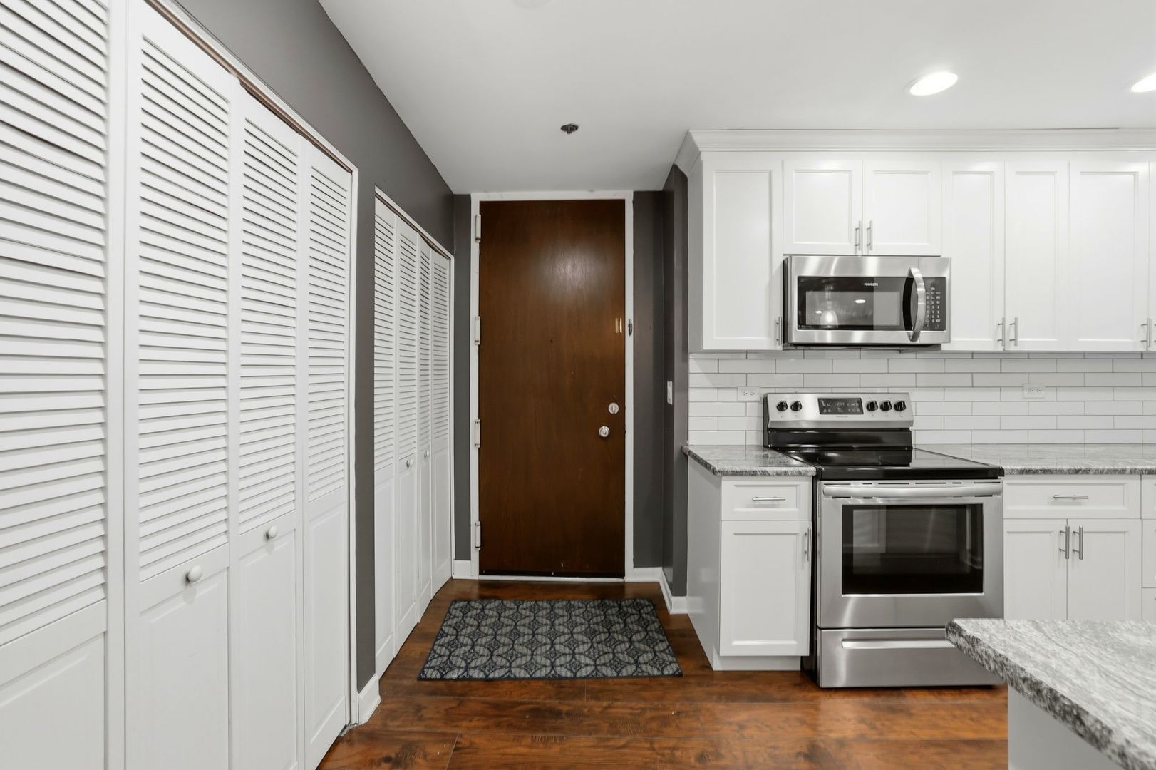 190 South Wood Dale Road, Unit 200 Wood Dale, IL 60191 - Photo 12 of 34 a kitchen with a stove and a microwave