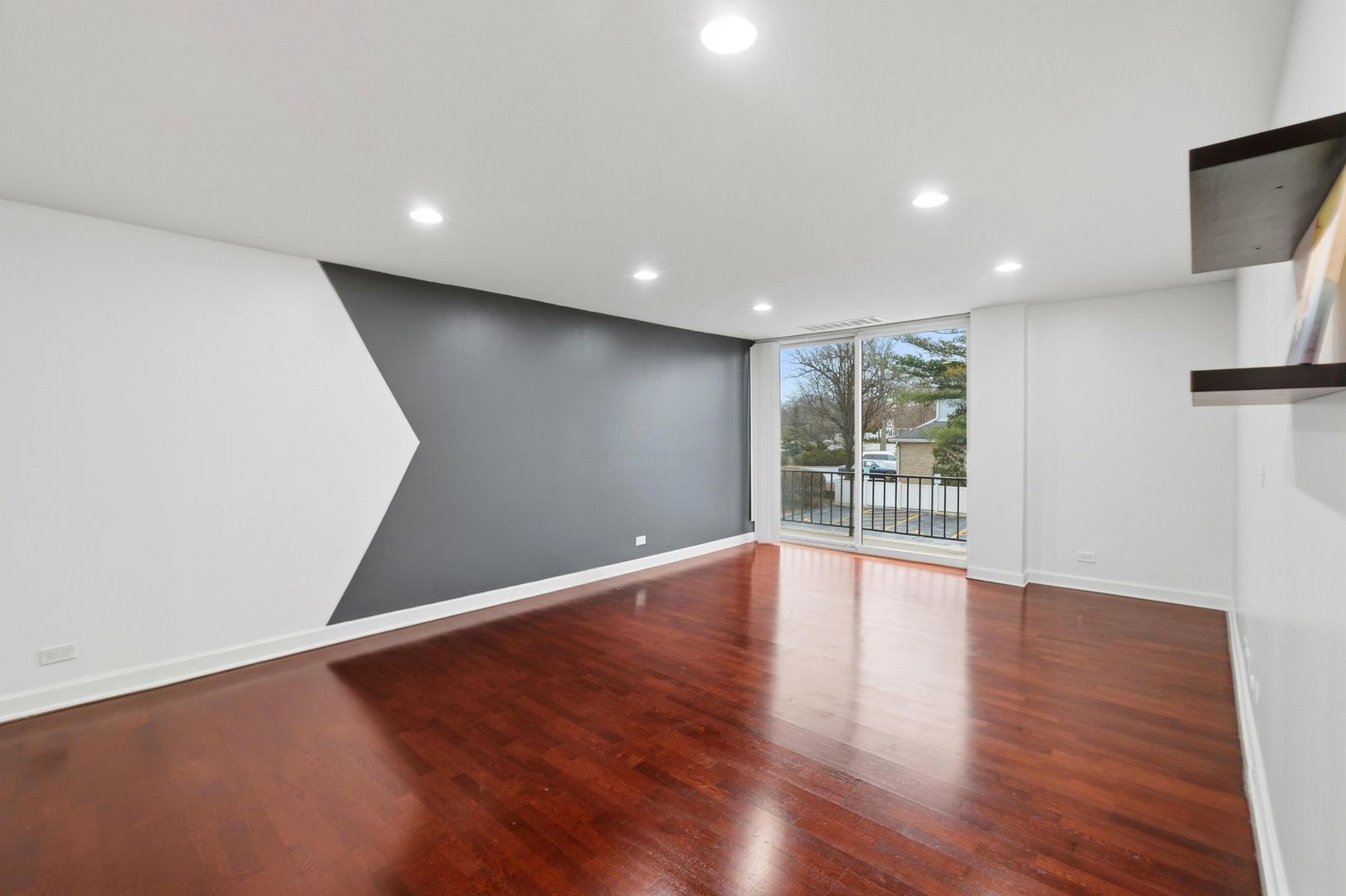 190 South Wood Dale Road, Unit 200 Wood Dale, IL 60191 - Photo 15 of 34 a view of an empty room with wooden floor and a window
