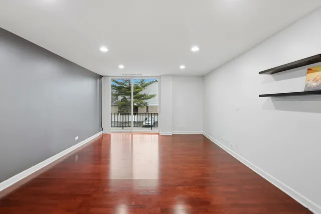 a view of kitchen with refrigerator and wooden floor
