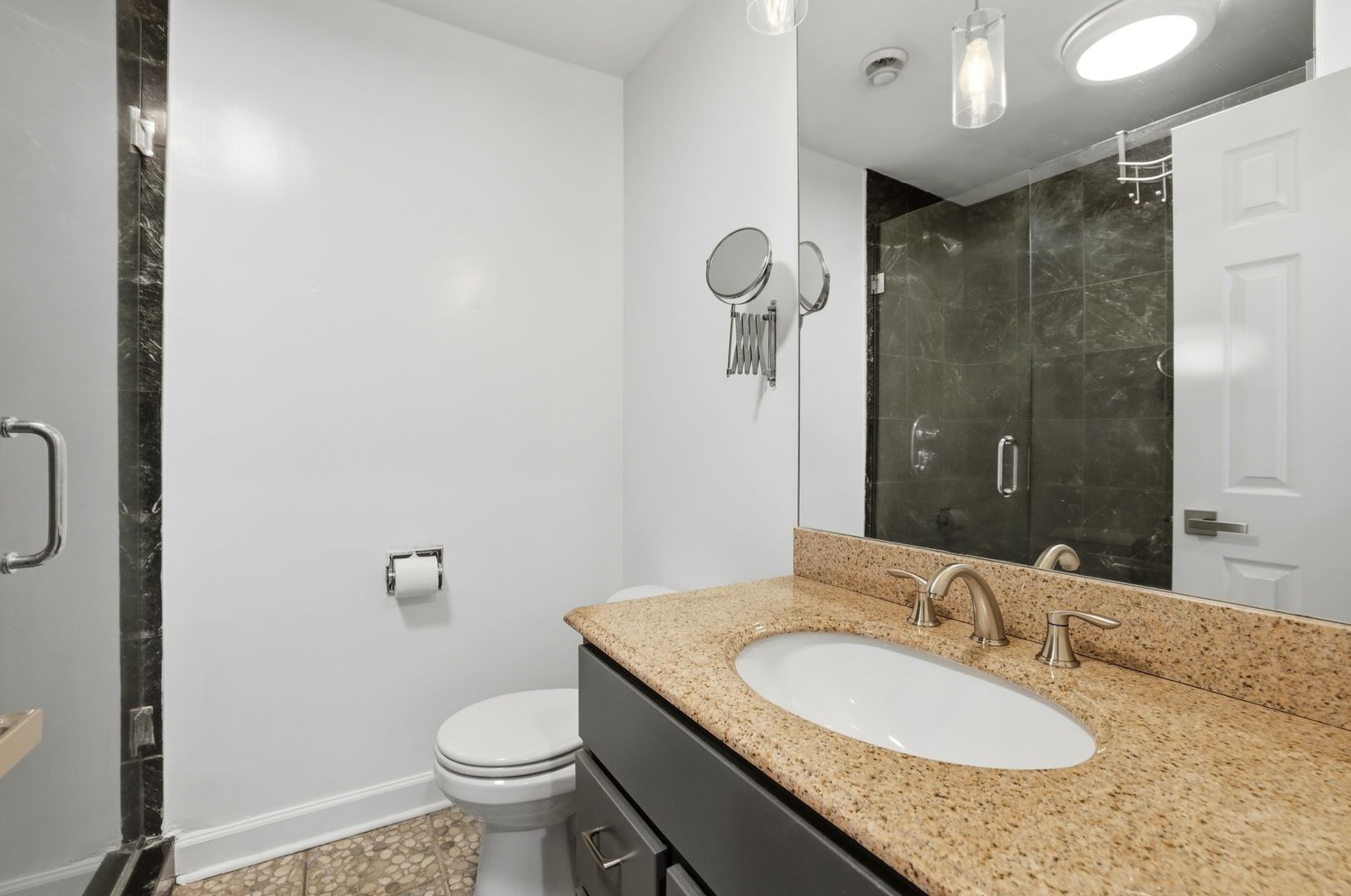 190 South Wood Dale Road, Unit 200 Wood Dale, IL 60191 - Photo 26 of 34 a bathroom with a granite countertop sink toilet and shower