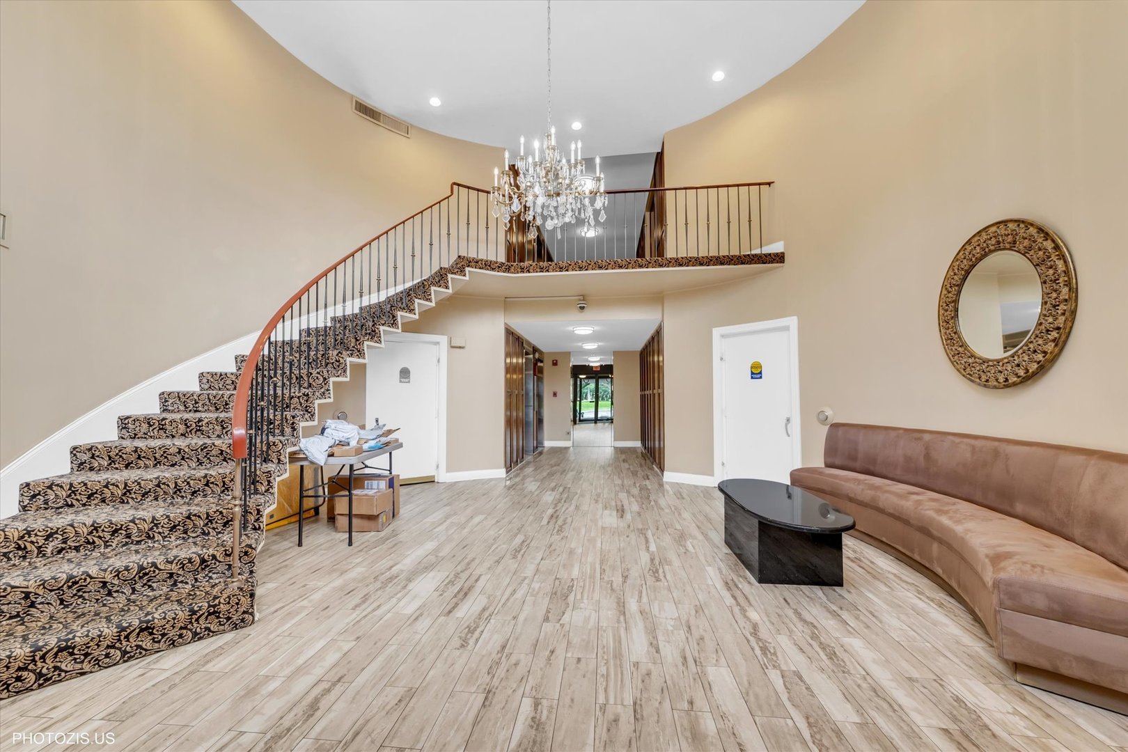 190 South Wood Dale Road, Unit 200 Wood Dale, IL 60191 - Photo 3 of 34 a living room with furniture and a chandelier