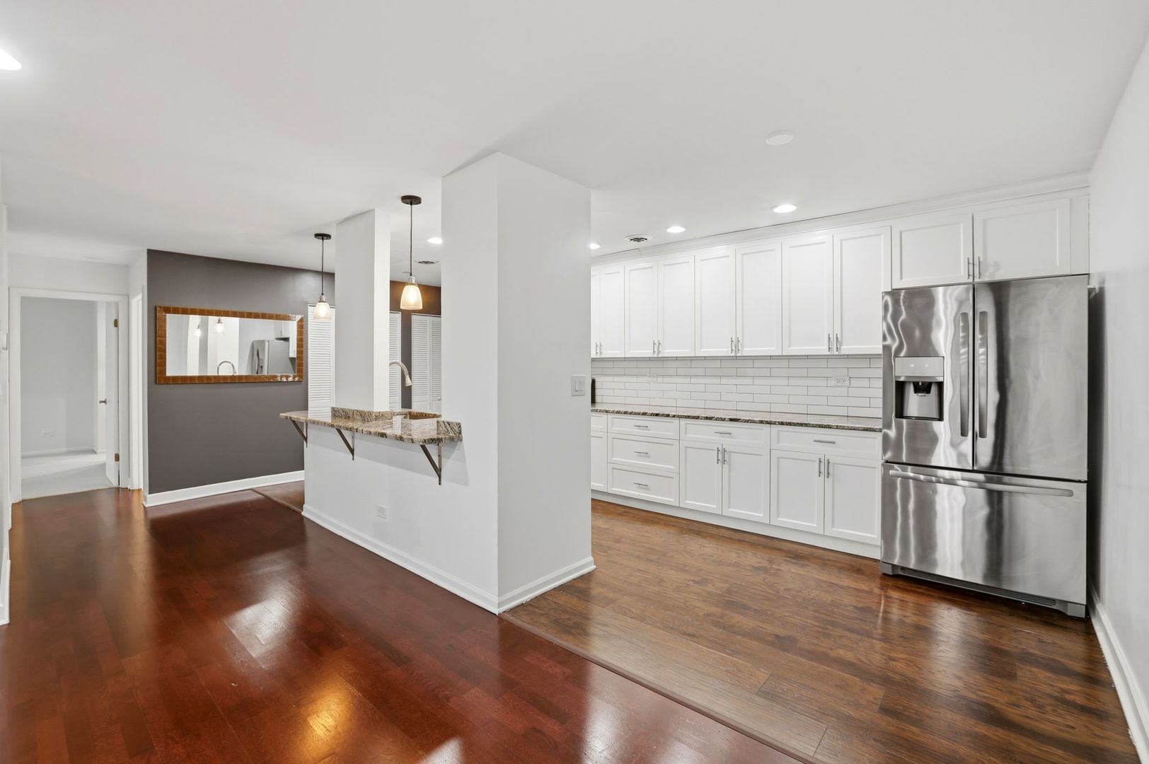 190 South Wood Dale Road, Unit 200 Wood Dale, IL 60191 - Photo 6 of 34 a kitchen with a refrigerator and wooden floor
