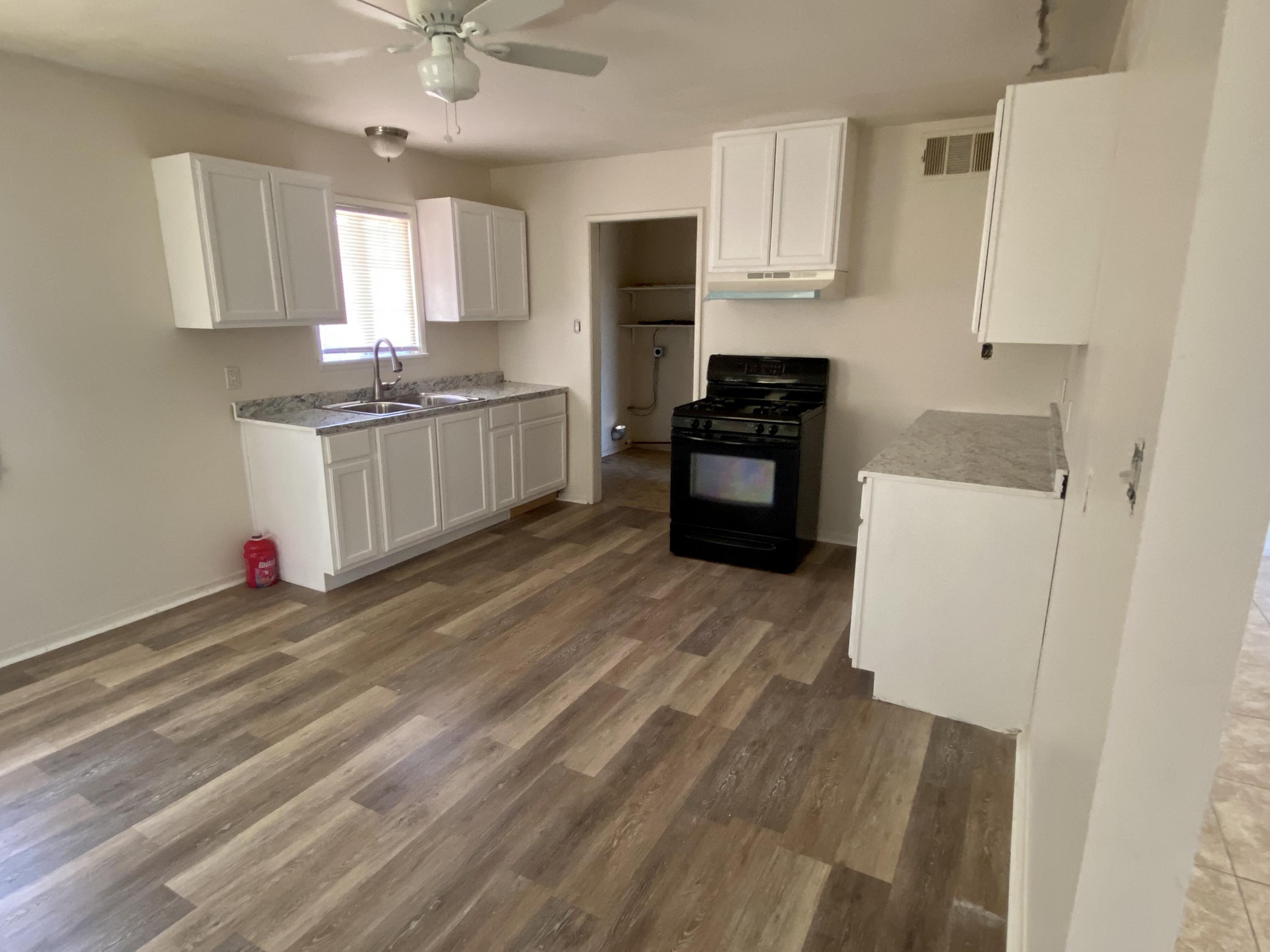 660 North 6th Street Blythe, CA 92225 - Photo 2 of 13 a kitchen with granite countertop a refrigerator stove top oven and sink