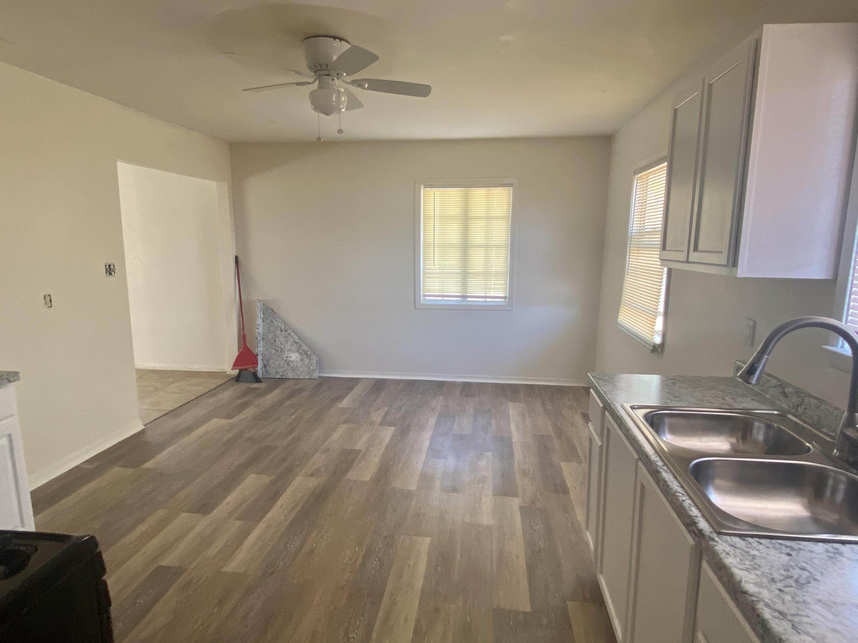 660 North 6th Street Blythe, CA 92225 - Photo 3 of 13 a kitchen with granite countertop a sink window and cabinets