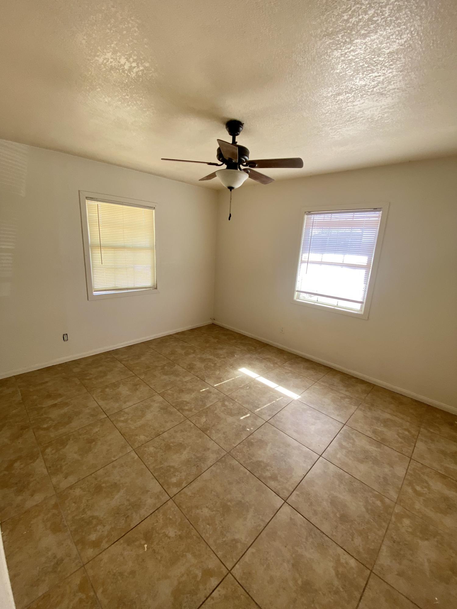 660 North 6th Street Blythe, CA 92225 - Photo 9 of 13 a view of a big room with windows and chandelier fan