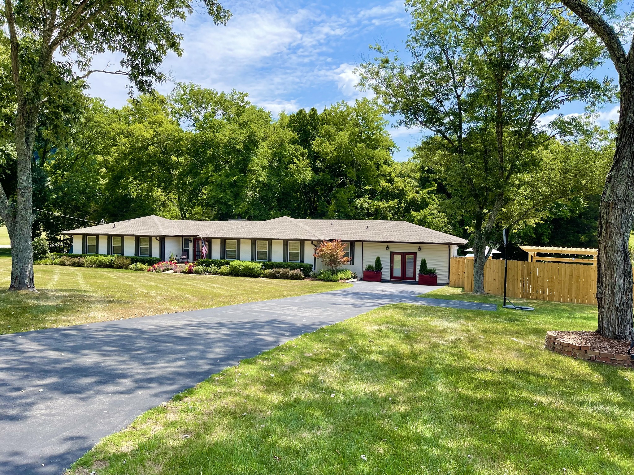a view of a house with swimming pool and a yard