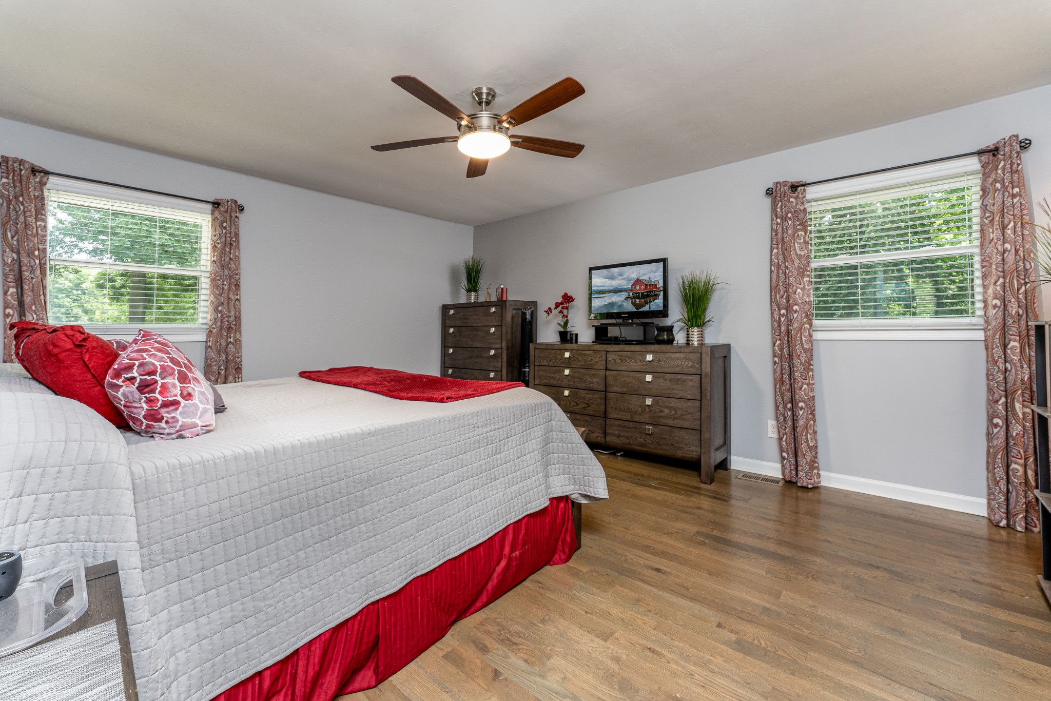 710 High Point Ridge Road Franklin, TN 37069 - Photo 15 of 32 a bedroom with a large bed a chandelier and a flat tv screen