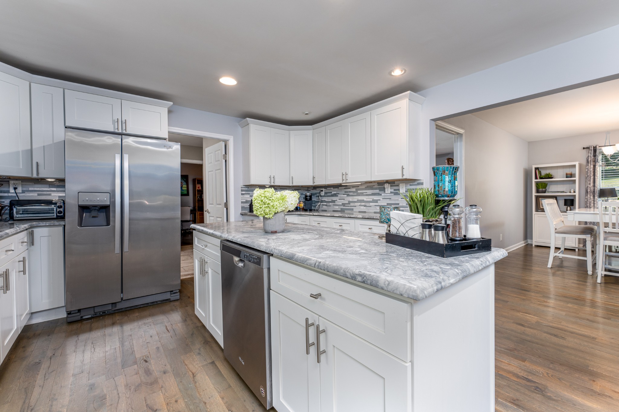 710 High Point Ridge Road Franklin, TN 37069 - Photo 19 of 32 a kitchen with stainless steel appliances granite countertop a refrigerator a sink a stove a dining table and chairs