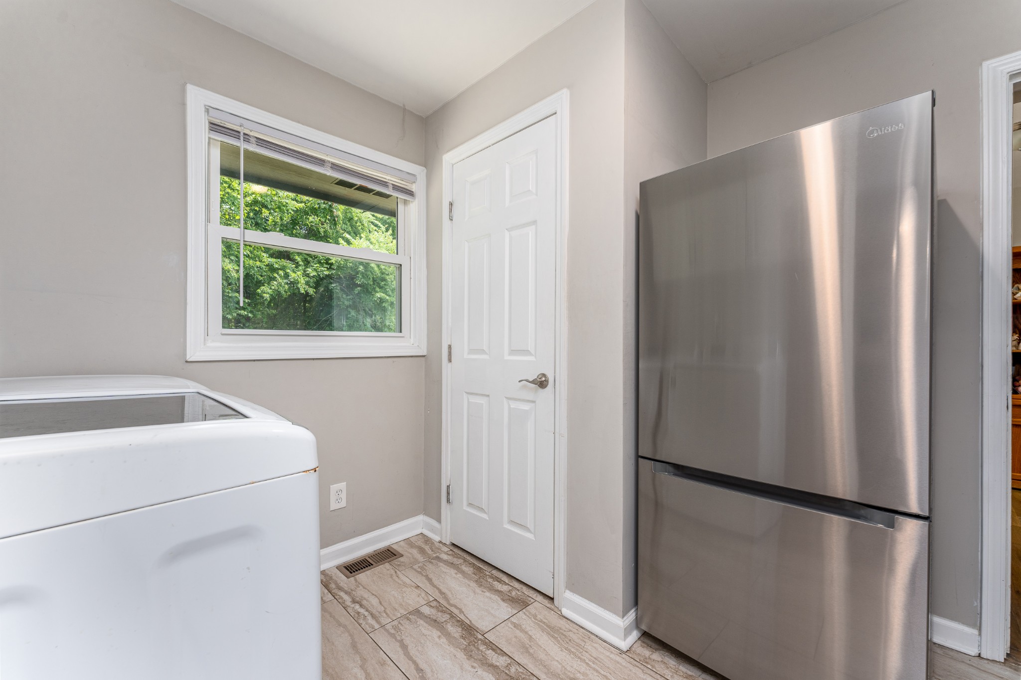 710 High Point Ridge Road Franklin, TN 37069 - Photo 28 of 32 a white refrigerator freezer and a wooden floor