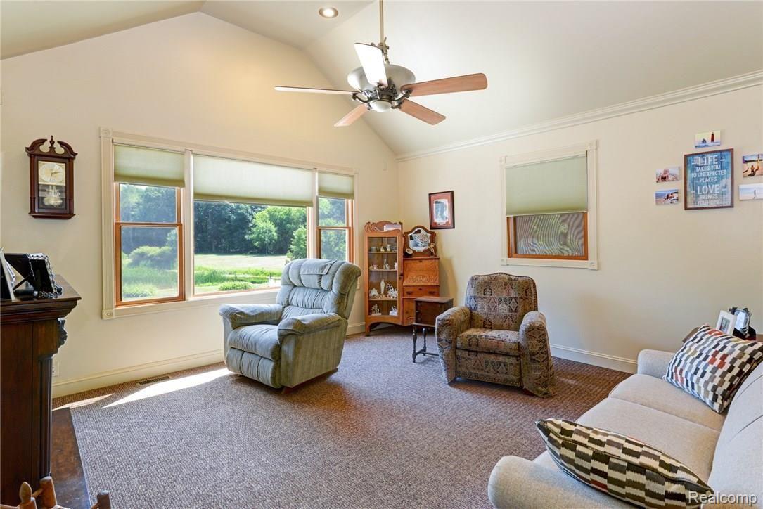 9675 Roberts Road Gregory, MI 48137 - Photo 15 of 33 Beautiful living room with vaulted ceiling and terrific view of the pond.