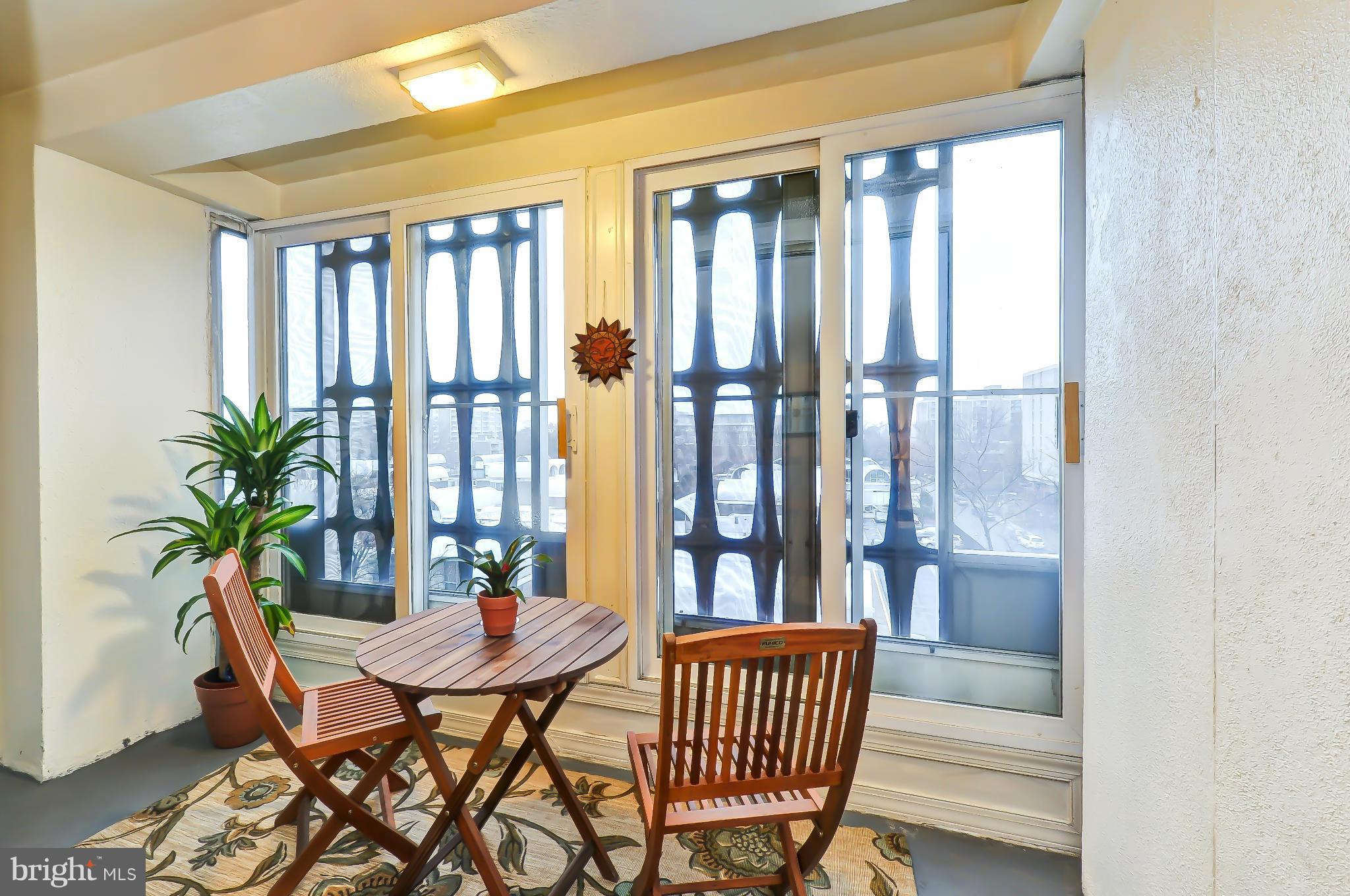 1301 Delaware Avenue Southwest, Unit N504 Washington, DC 20024 - Photo 2 of 29 a dining room with furniture window and wooden floor