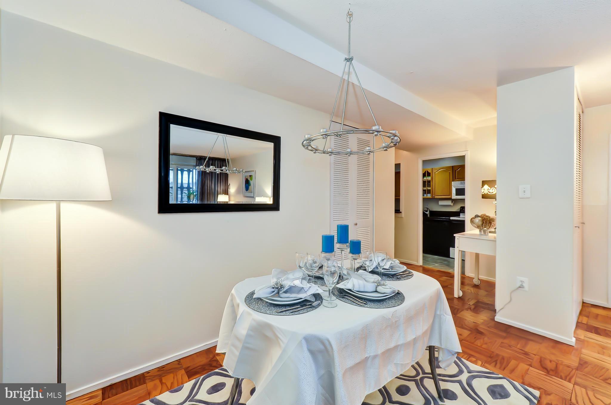 1301 Delaware Avenue Southwest, Unit N504 Washington, DC 20024 - Photo 5 of 29 a view of a dining room with furniture and wooden floor