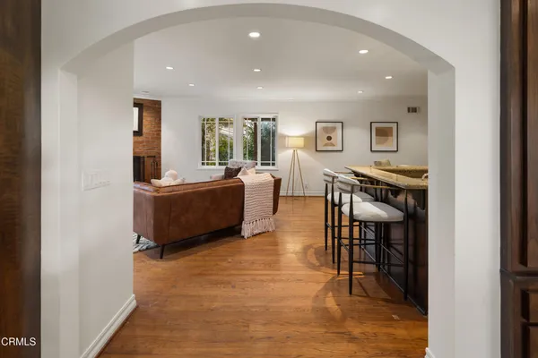 a living room with furniture wooden floor and a fireplace