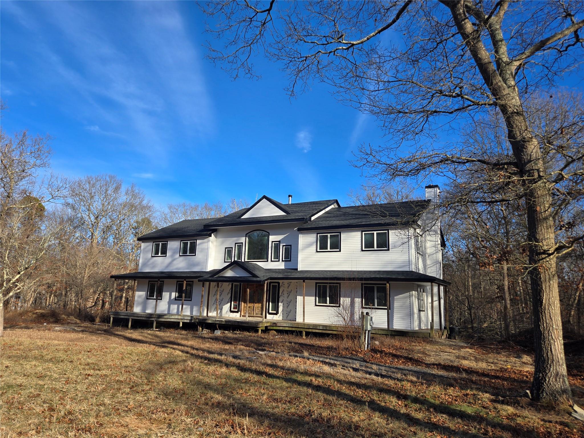 85 Smith Road Ridge, NY 11961 - Photo 1 of 26 View of front of home with a chimney, a porch, and a front lawn