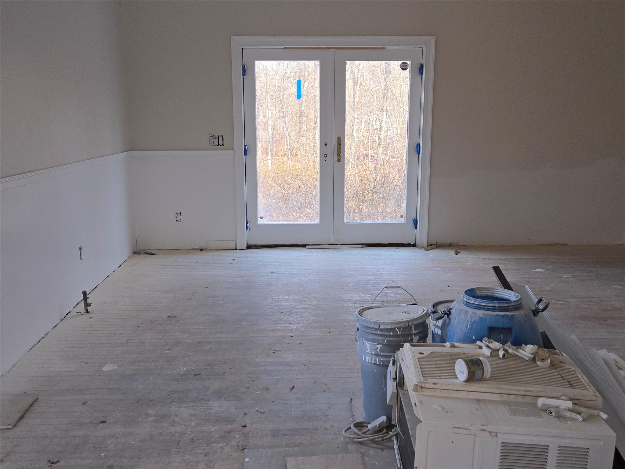 85 Smith Road Ridge, NY 11961 - Photo 7 of 26 Unfurnished room with french doors and wood finished floors
