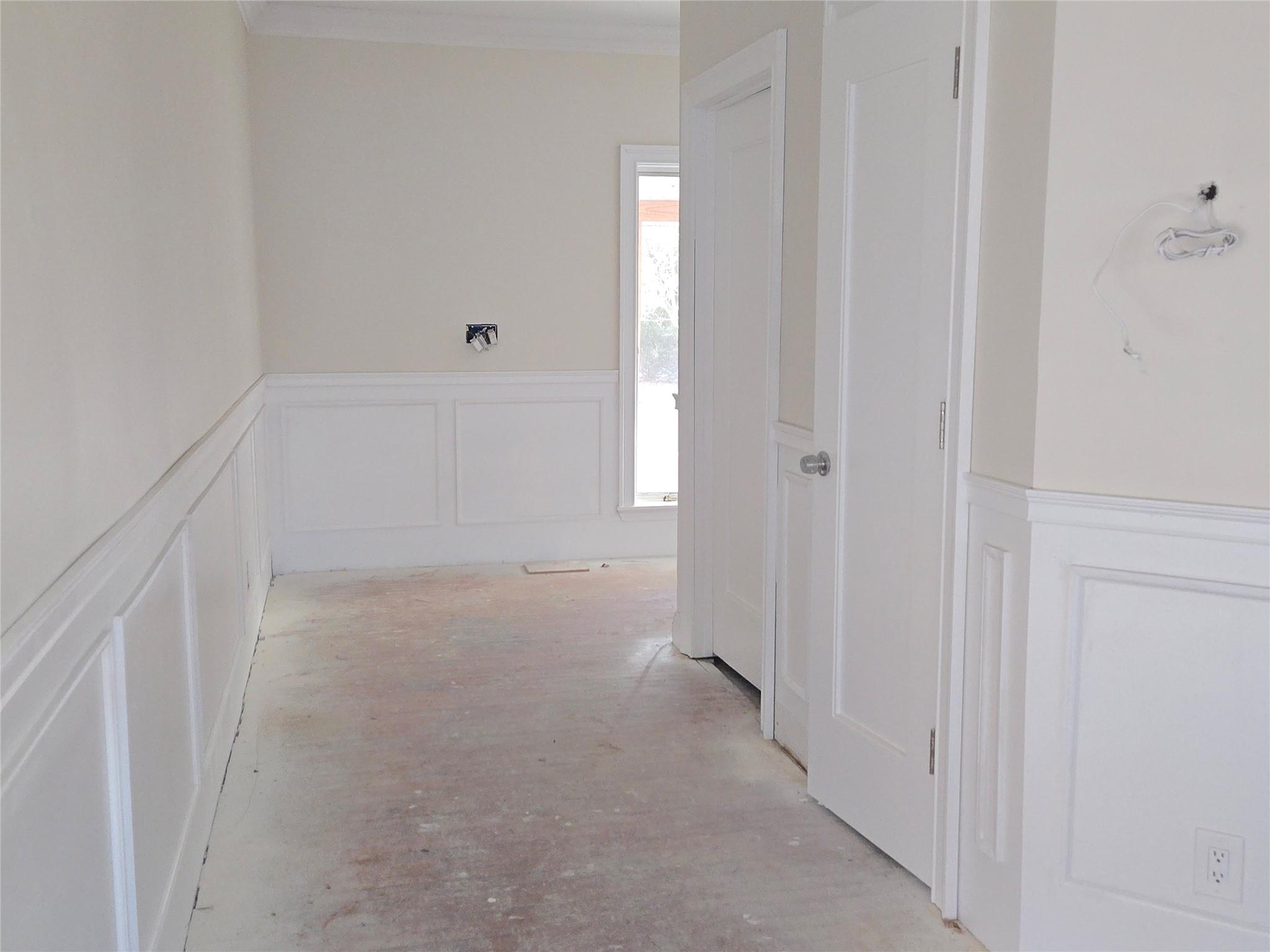 85 Smith Road Ridge, NY 11961 - Photo 10 of 26 Hallway with a decorative wall, wainscoting, and crown molding