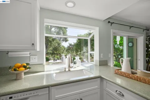 a kitchen with a sink and a large window