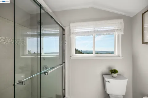 a bathroom with a window shower and a sink
