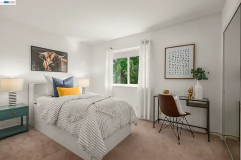 a bedroom with a bed and a workspace