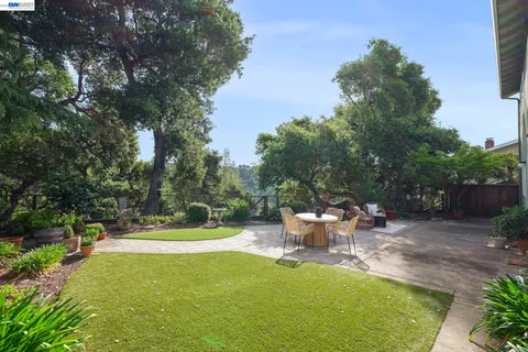 a view of a backyard with sitting area