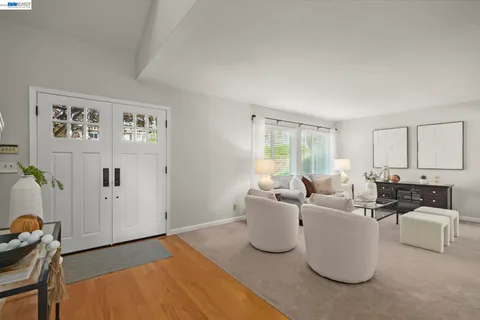 a living room with furniture a window and a table