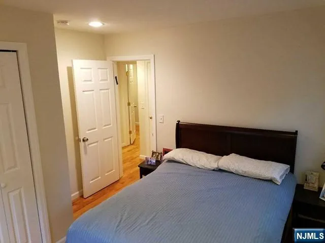 a bedroom with a bed and a mirror