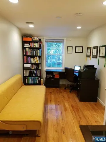 a living room with furniture window and wooden floor