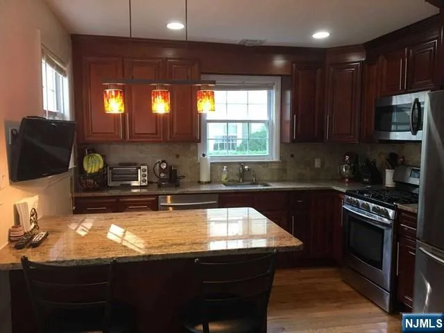 a kitchen with a sink a stove and a microwave