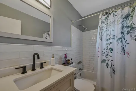 a bathroom with a sink toilet and a mirror