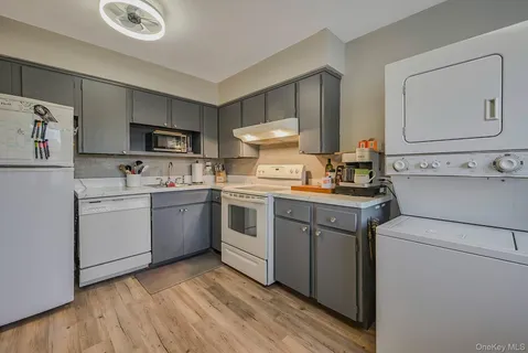a kitchen with a sink cabinets and wooden floor