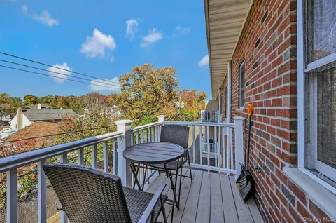 a view of balcony with furniture