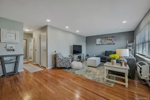 a bedroom with furniture and a wooden floor