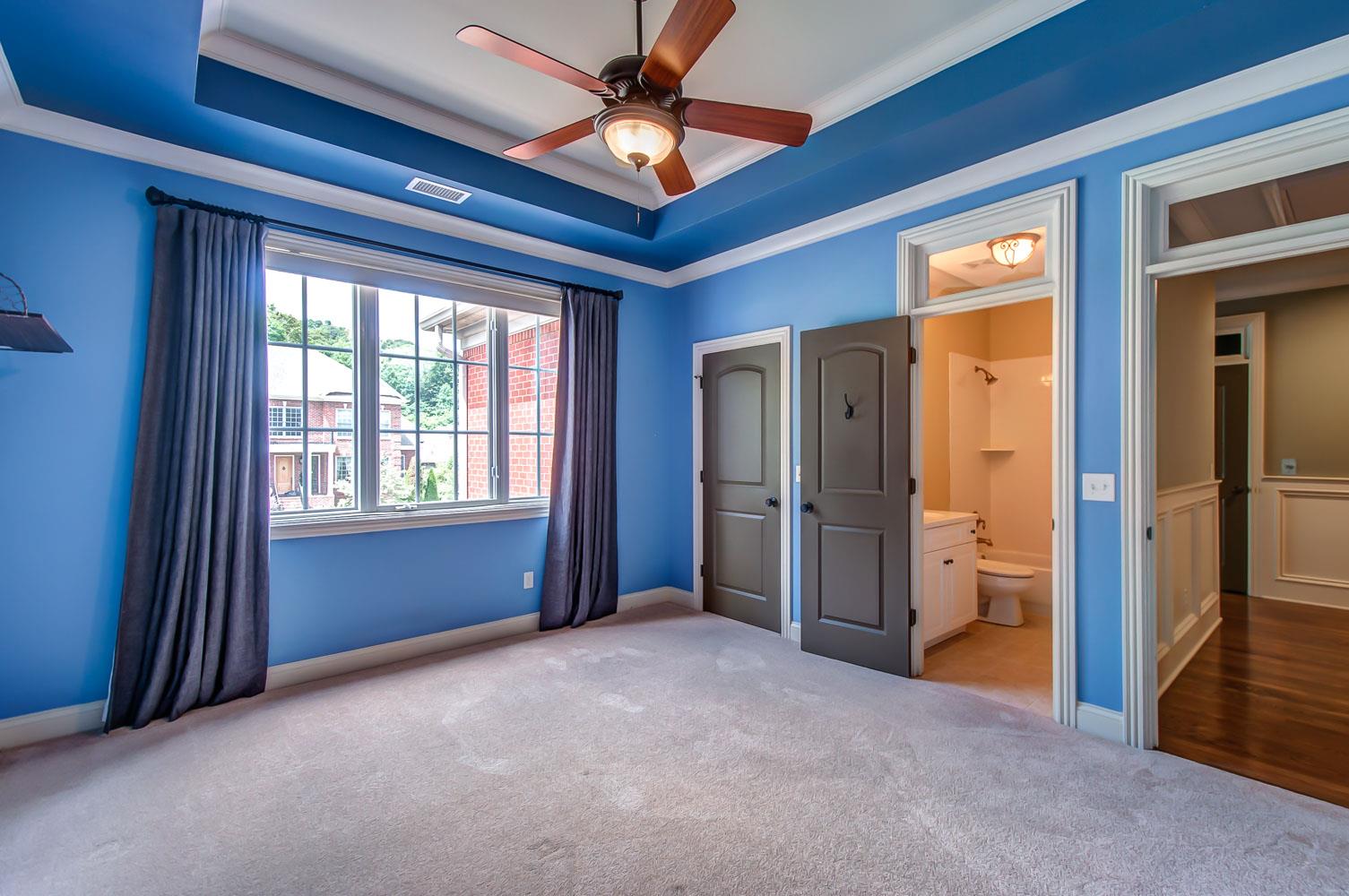 476 Sandcastle Road Franklin, TN 37069 - Photo 17 of 23 a view of an empty room with a fireplace and a chandelier