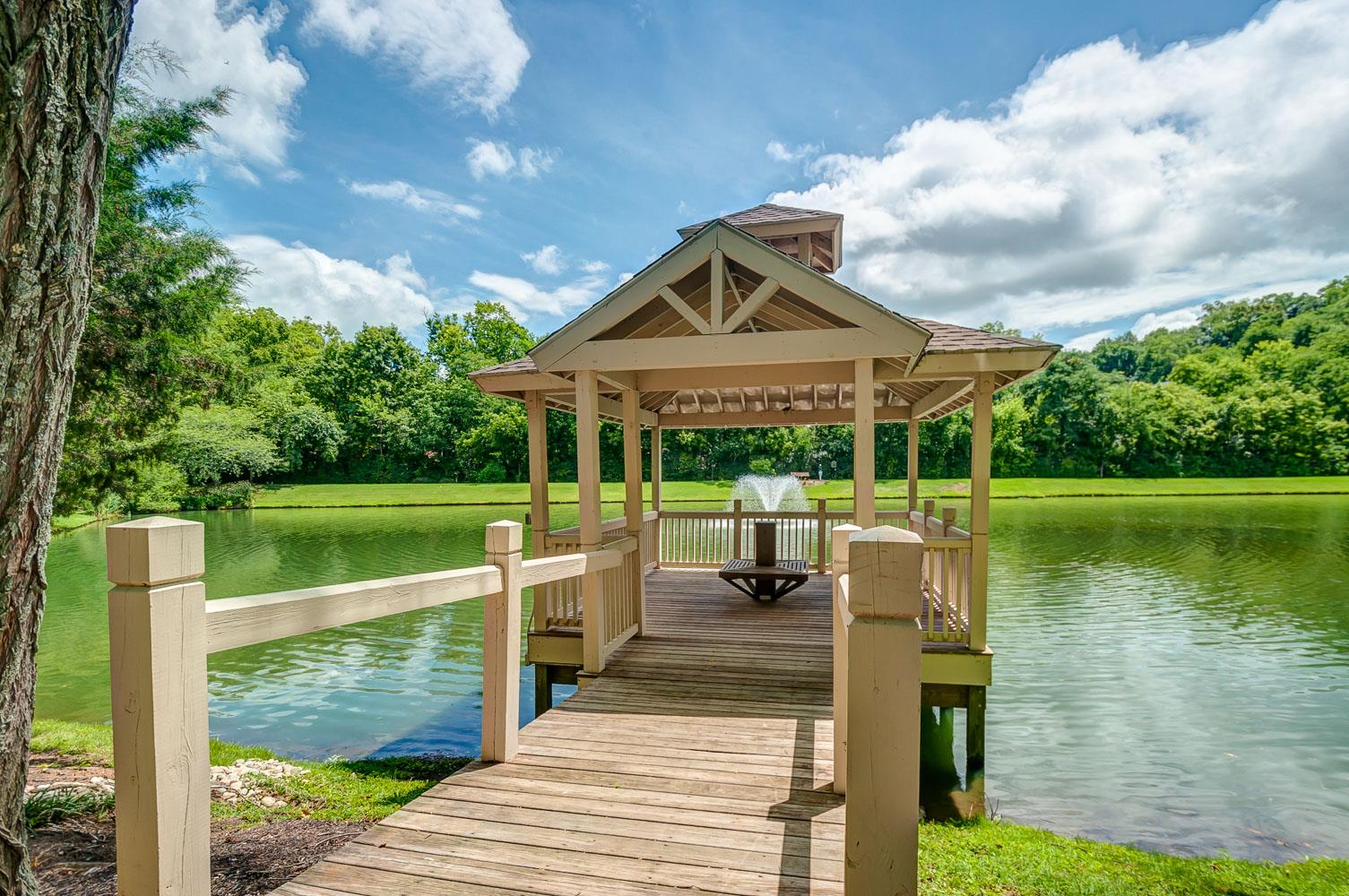 476 Sandcastle Road Franklin, TN 37069 - Photo 23 of 23 a view of a lake with a big yard potted plants and large tree