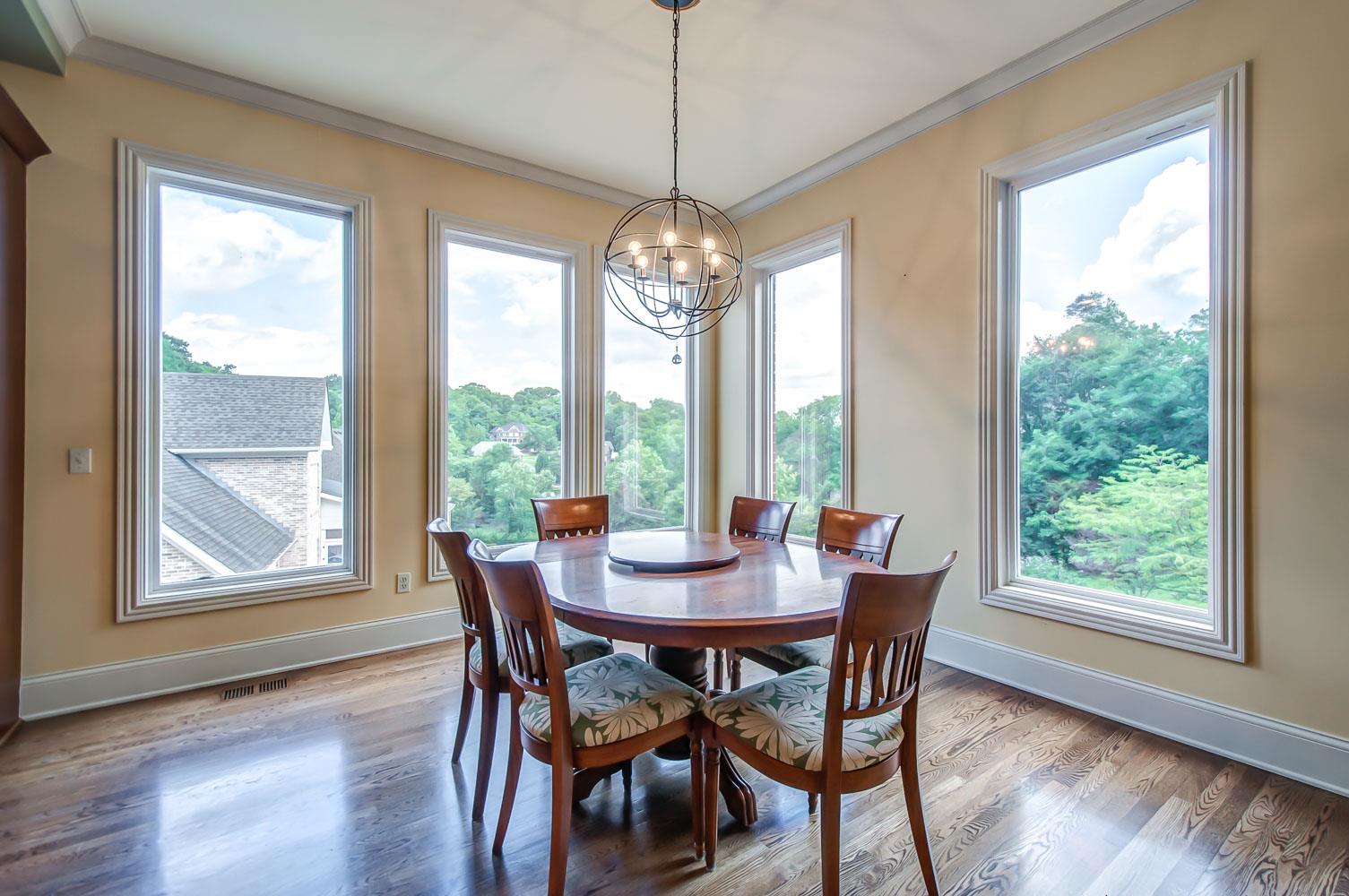 476 Sandcastle Road Franklin, TN 37069 - Photo 9 of 23 a view of a dining room with furniture large windows and wooden floor