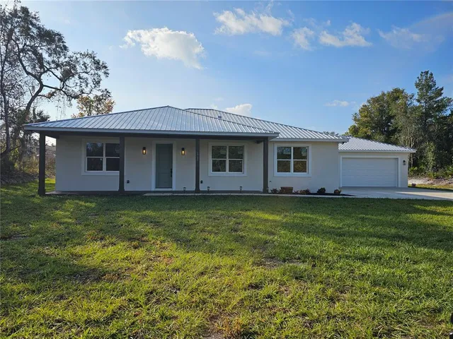 a view of a house with a backyard