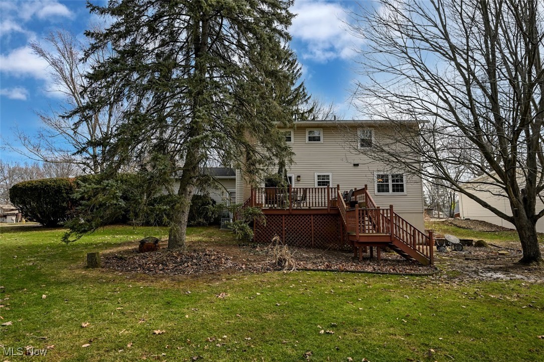 3305 Edington Road Akron, OH 44333 - Photo 40 of 46 Rear view of house with a wooden deck, a lawn, and stairway