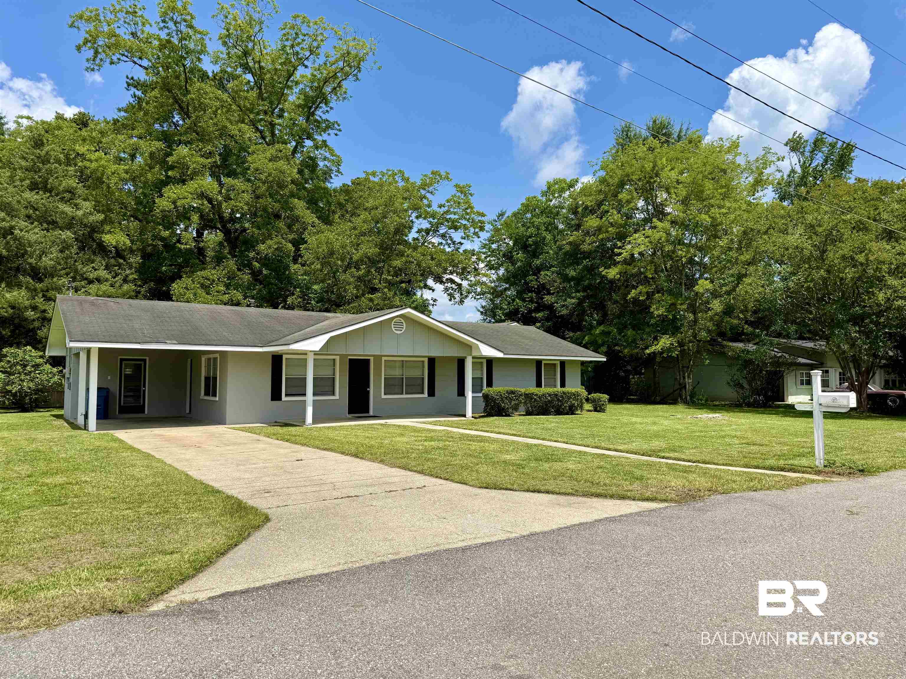 103 Kimberly Street Brewton, AL 36426 - Photo 18 of 18 Ranch-style home featuring concrete driveway, an attached carport, and a front lawn