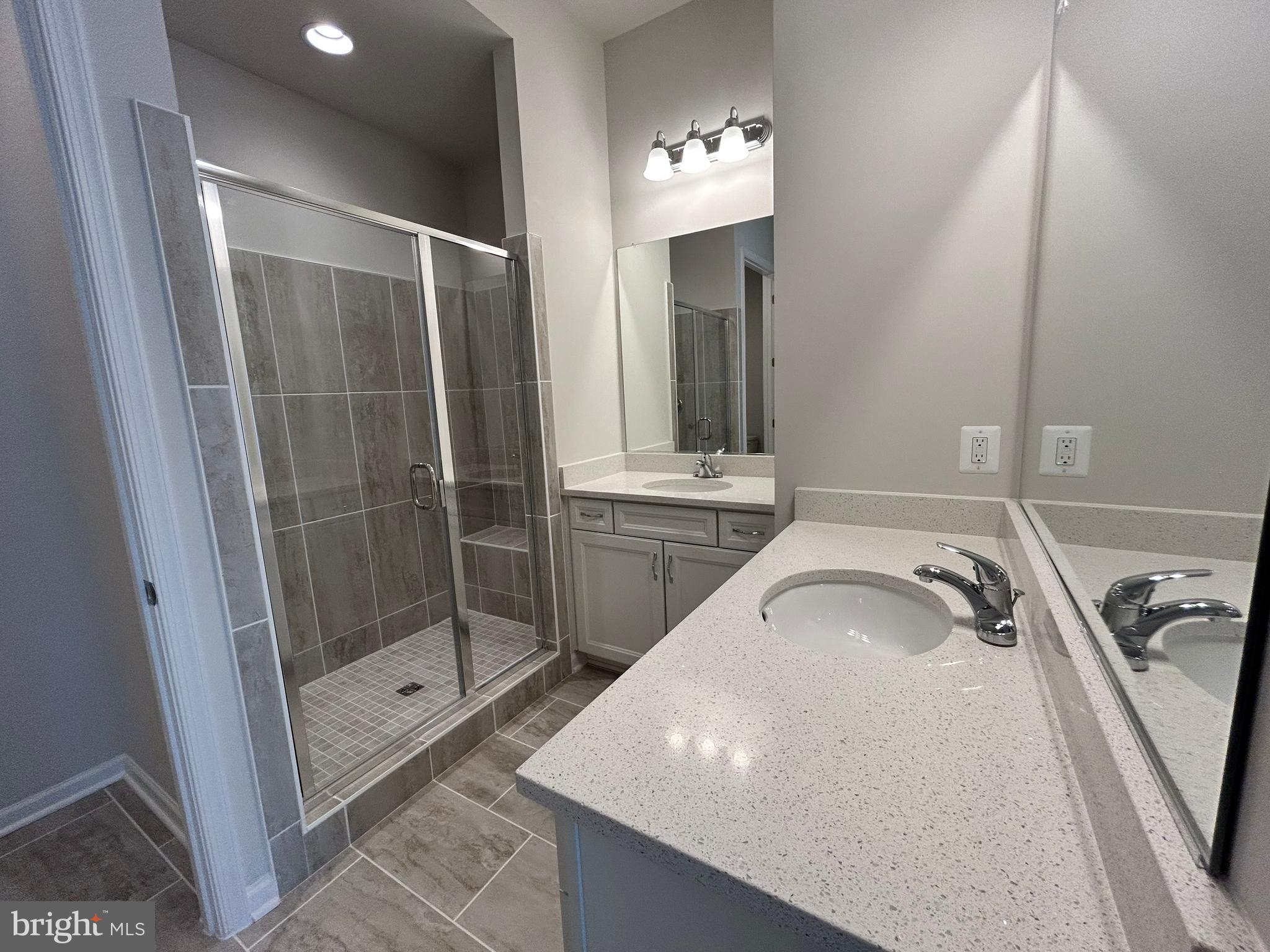 9370 Crestview Rdg Drive Bristow, VA 20136 - Photo 16 of 31 a bathroom with a sink a mirror and shower