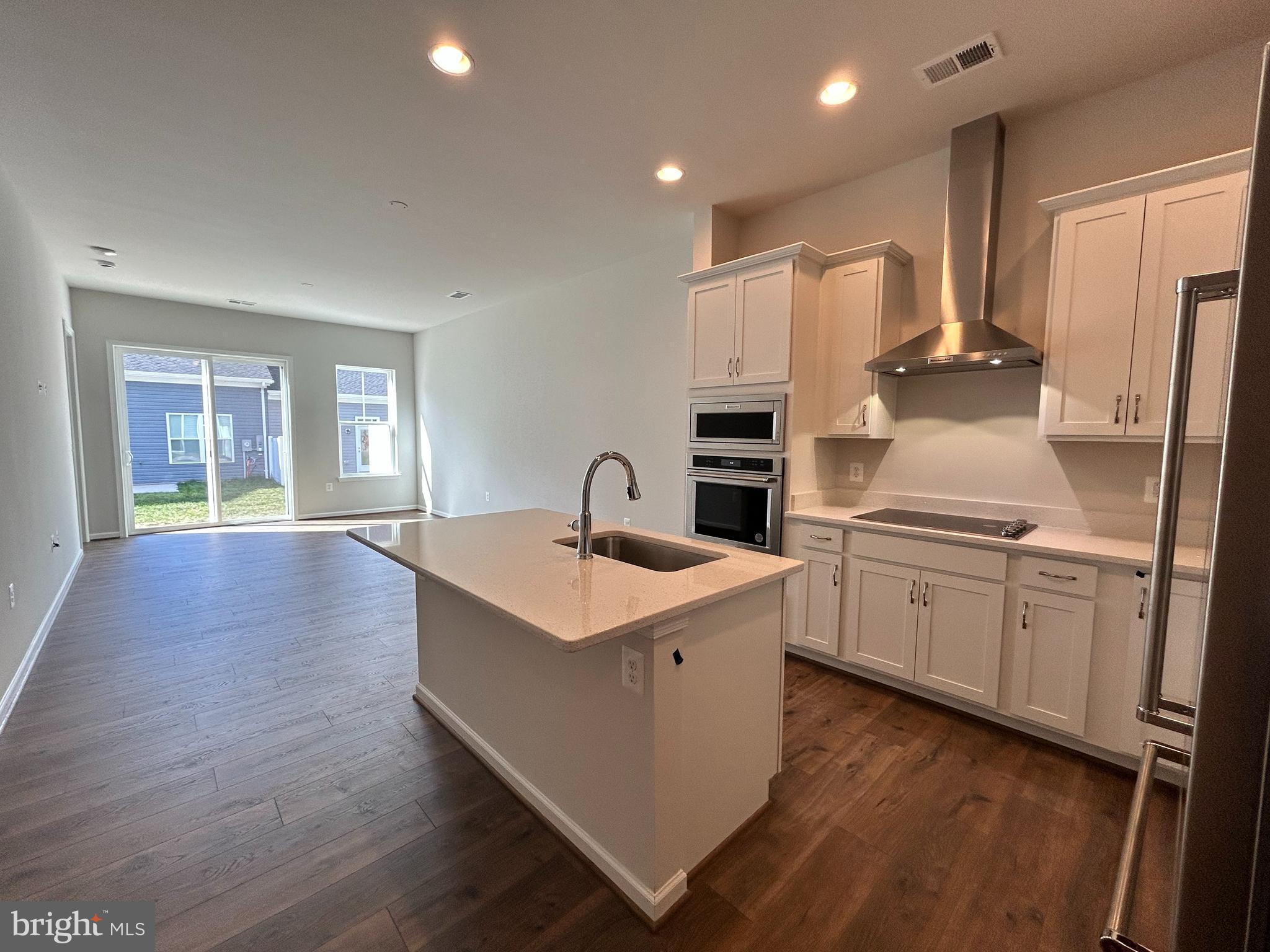 9370 Crestview Rdg Drive Bristow, VA 20136 - Photo 7 of 31 a kitchen with sink cabinets and wooden floor