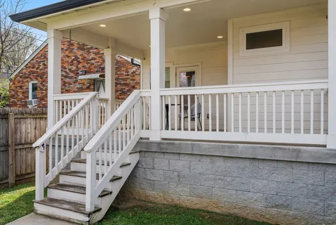 a view of balcony with wooden floor and fence