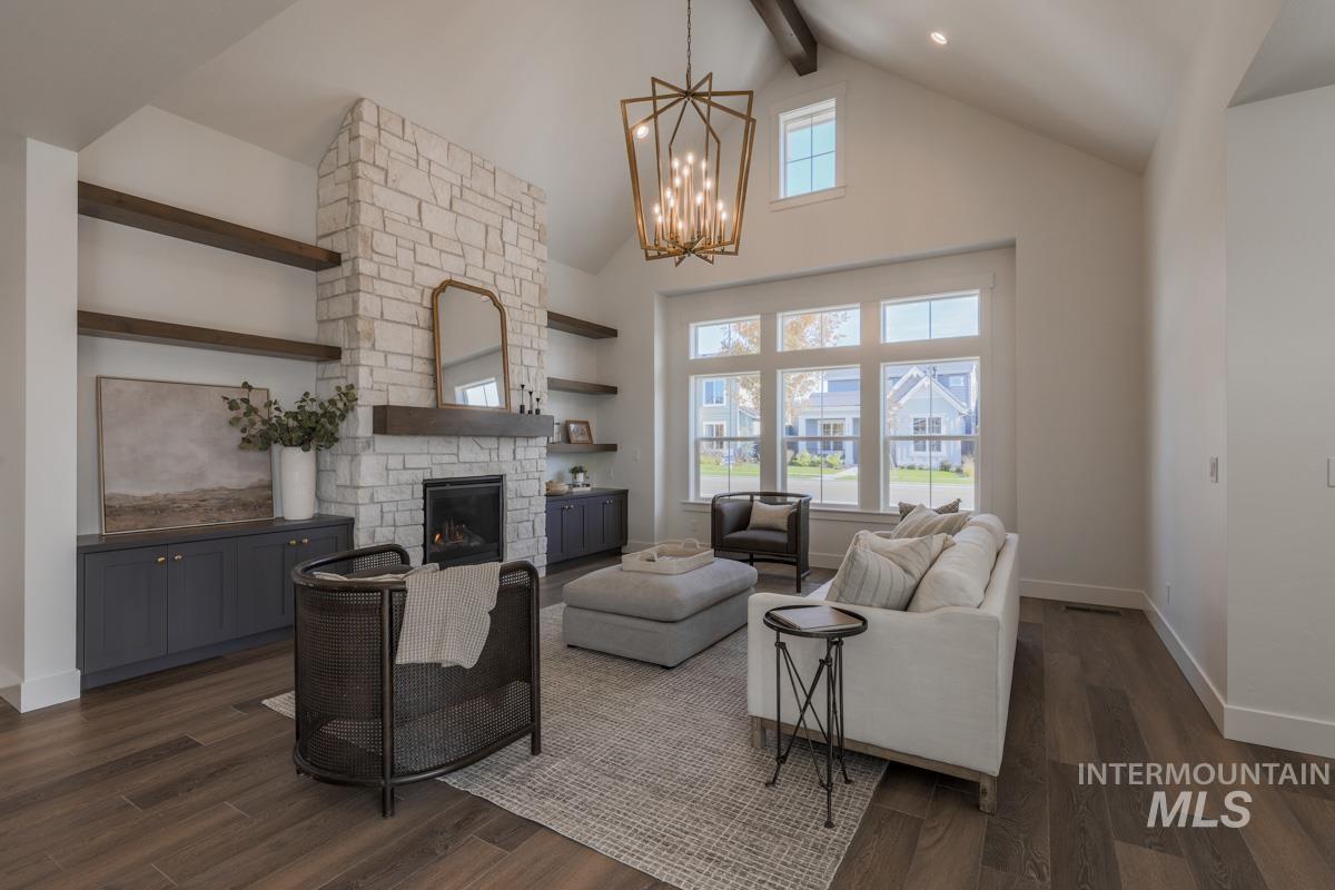 6091 South Apex Avenue Meridian, ID 83642 - Photo 3 of 40 Living room featuring beamed ceiling, high vaulted ceiling, plenty of natural light, a stone fireplace, and dark wood finished floors