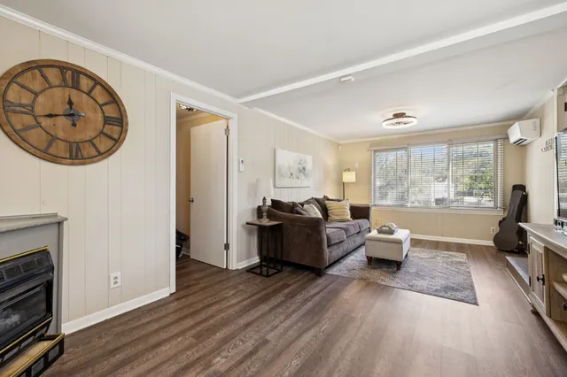 a view of a house with a small yard and floor to ceiling window