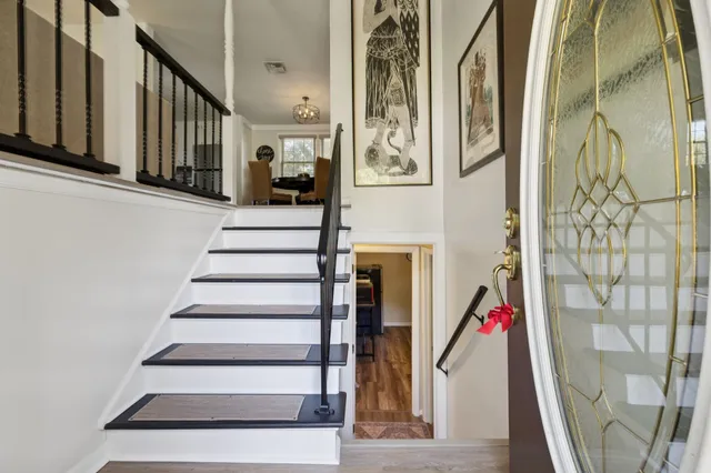 a living room with furniture a flat screen tv and a large window